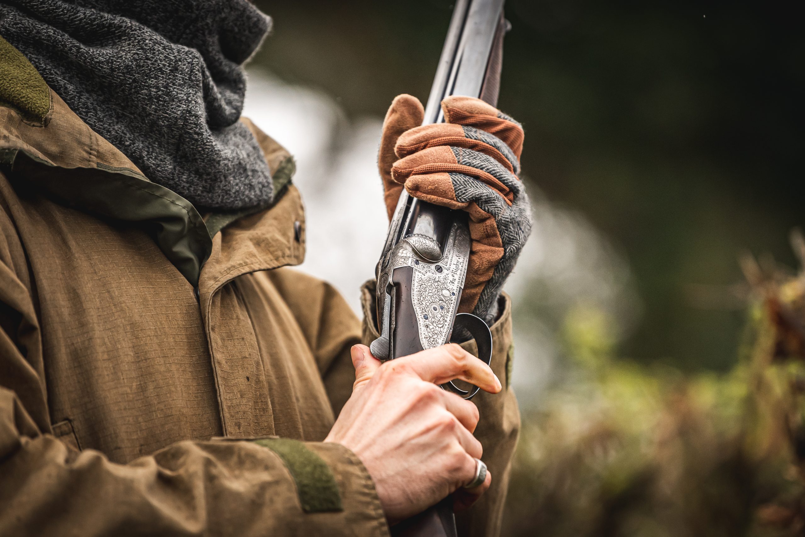 Man with side by side shotgun in hands