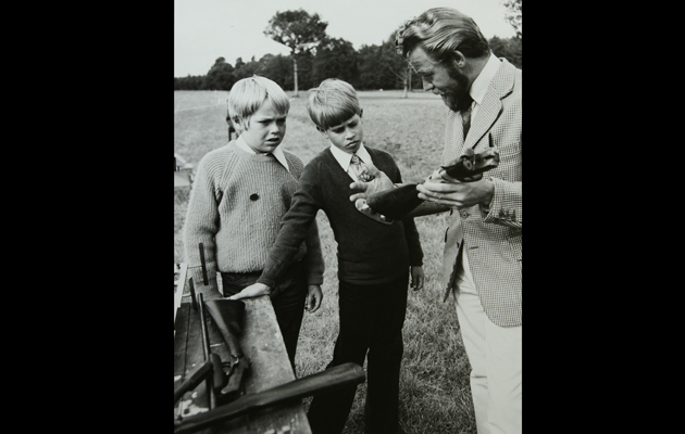 Prince Edward is taken through the components of a gun