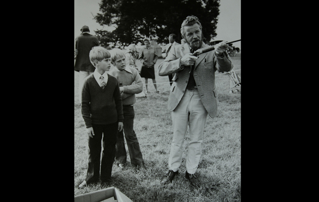 Prince Edward is shown the correct technique for firing a shotgun