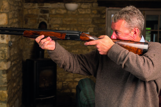 Man practising dry-mounting with shotgun