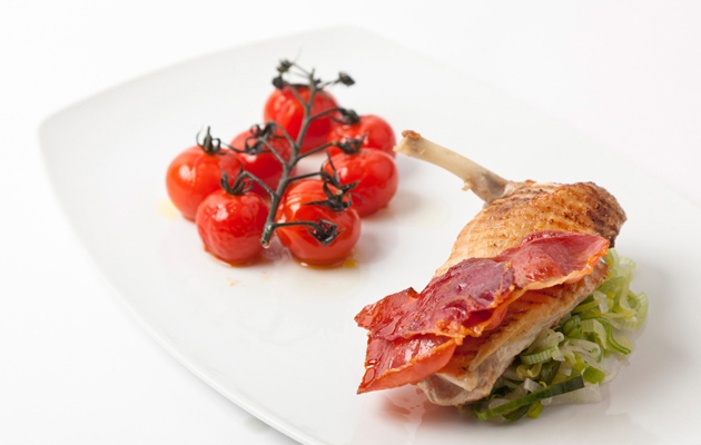 Grilled guinea fowl with crispy ham and roasted vine tomatoes