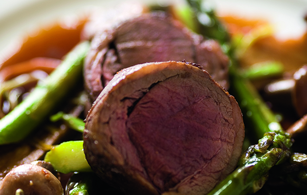 Pot roasted saddle of venison with mushrooms and asparagus