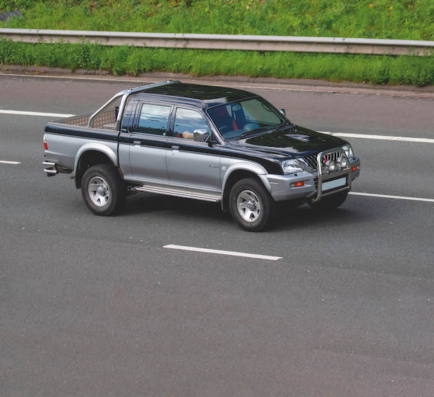 2002 black silver Mitsubishi L200 2.5td 4life 4WD; Vehicular traffic moving vehicles, cars driving vehicle on UK roads, motors, motoring on the M6 motorway highway network.