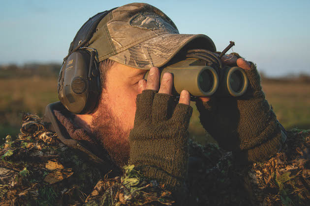 wildfowler using binoculars 