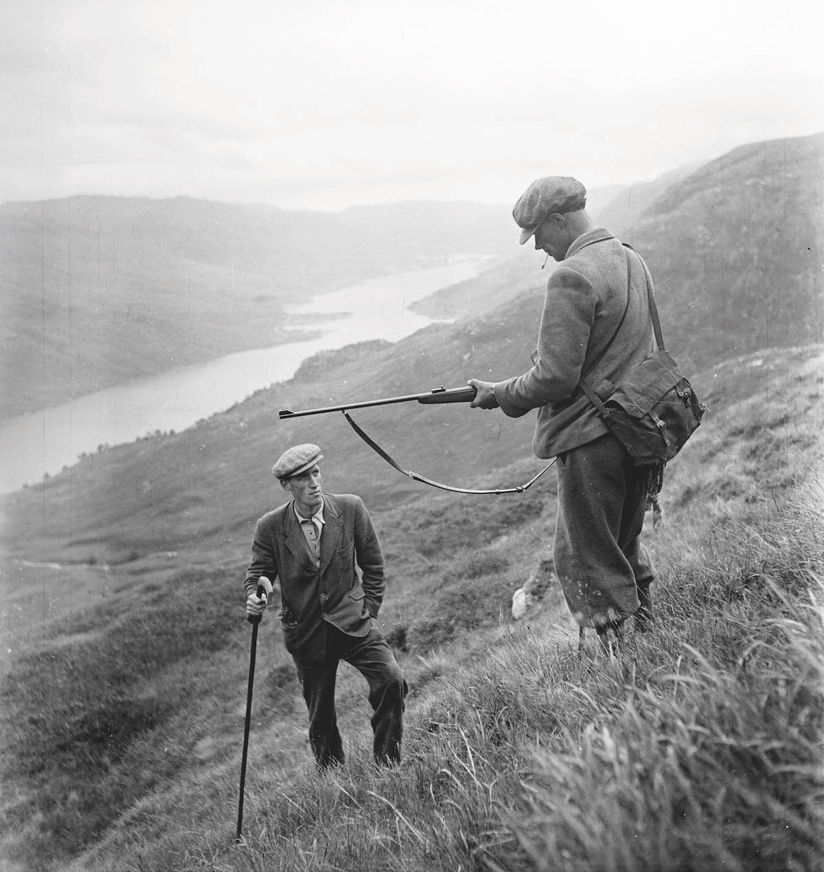 Deer stalkers on hill in 1950s