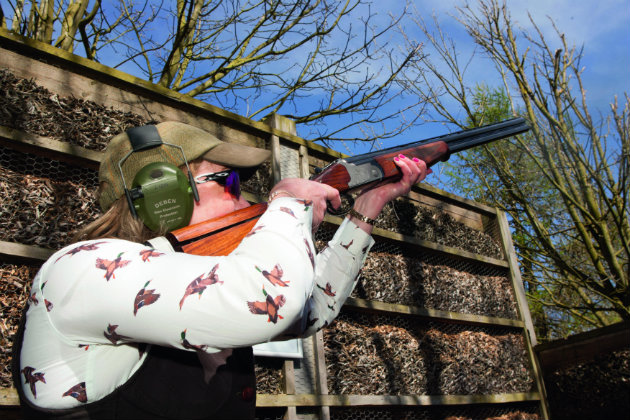 Woman shooting shotgun 