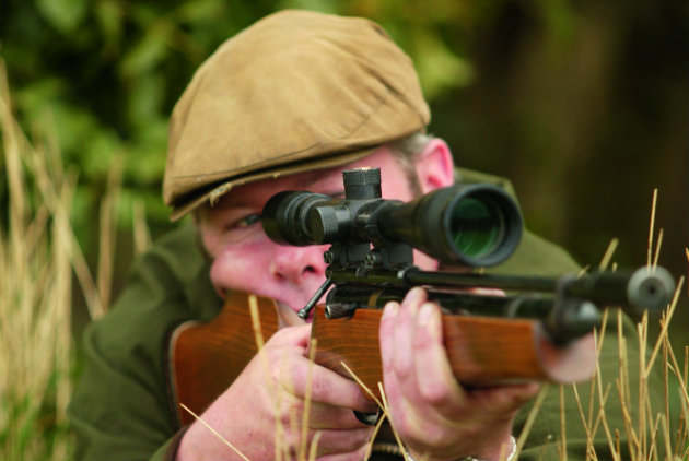 man shooting rifle 