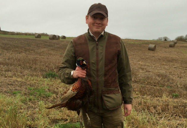 man holding pheasant