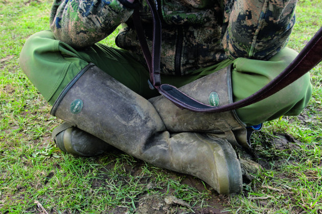 man cross legged with rifle 