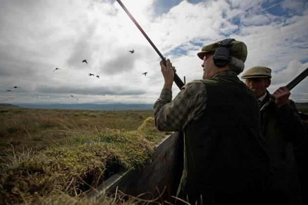 men with side by side oldfashioned shotguns 