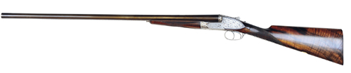  /></noscript></p>
<p>They were made for competition shooting before the advent of clays, when live pigeons were placed into a container and then released.</p>
<p>The competitor had to shoot the pigeon to drop within a semi-circle within a certain distance for it to be classed as a kill.</p>
<p>Though this might seem a little barbaric now, these unusual guns remain perfect for pigeon shooting.</p>
<p>They are always very tightly choked and heavy, the forerunner of the modern sporting gun.</p>
<p>We currently have a 1910 gun in stock with sideclips and 30″ barrels. This gun has had modern Teague multi-chokes fitted and weighs 7¼lbs.</p>
<p>This gun would be ideal for use in a hide where the pigeons aren?t playing the game, and skirting outside the decoy path.</p>
<p>A good shot using an appropriate load would find it ideal for clean kills 50-60 yards out.</p>
<p>You might also find some success with the gun when roost shooting.</p>
<p>Although heavy, these guns are generally superbly balanced and also good-looking, as you would expect of a best London gun.</p>
<p>When shooting with slightly bigger loads it would be the ultimate pigeon gun – fun, a little extravagant but very effective.</p>
<h2><a href=