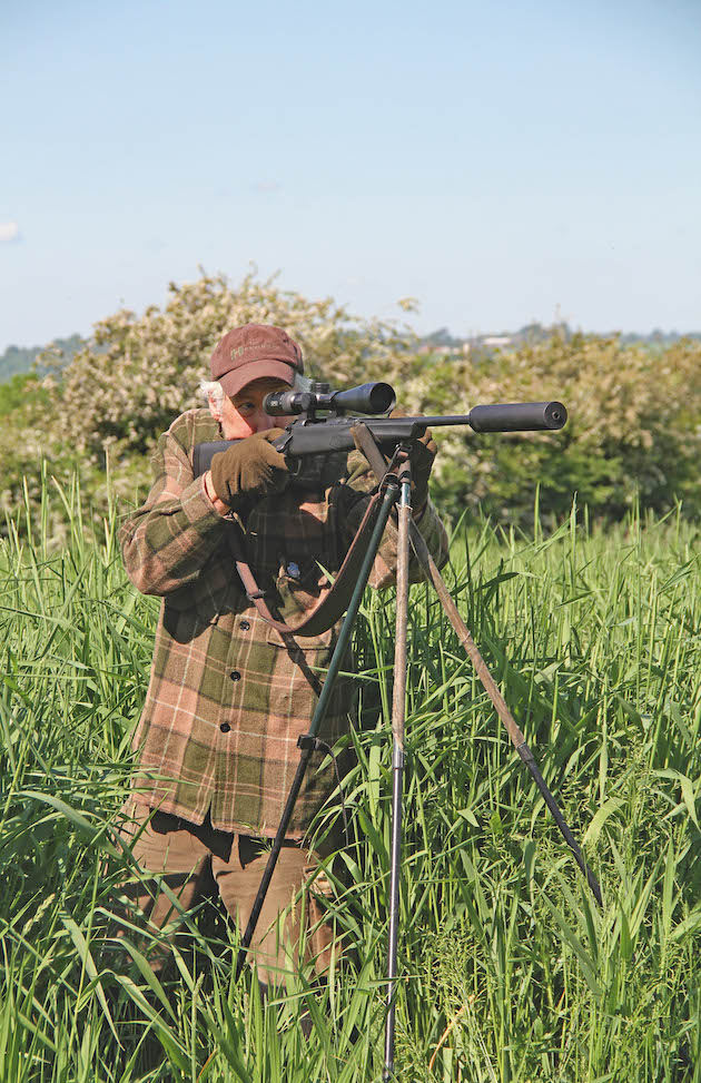 shooting rifle in field