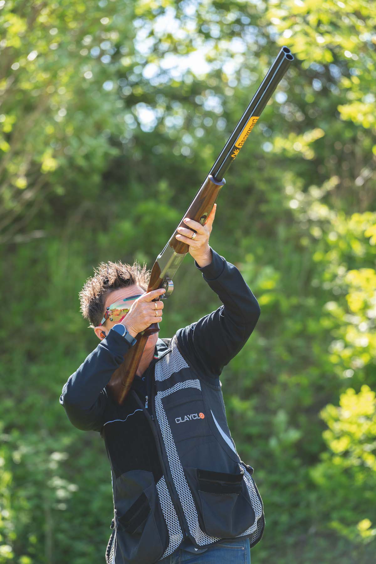 Woman shooting shotgun 