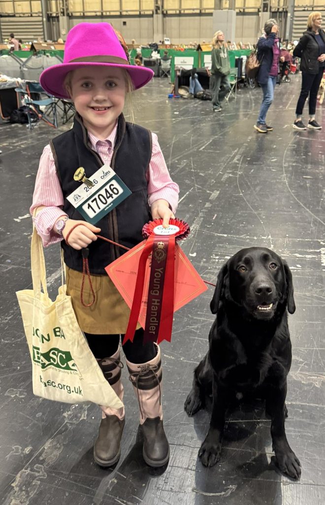 Nancy Unwin, 8, winner of the BASC gamekeeping class for Best Young Handler Under 14, alongside Finn