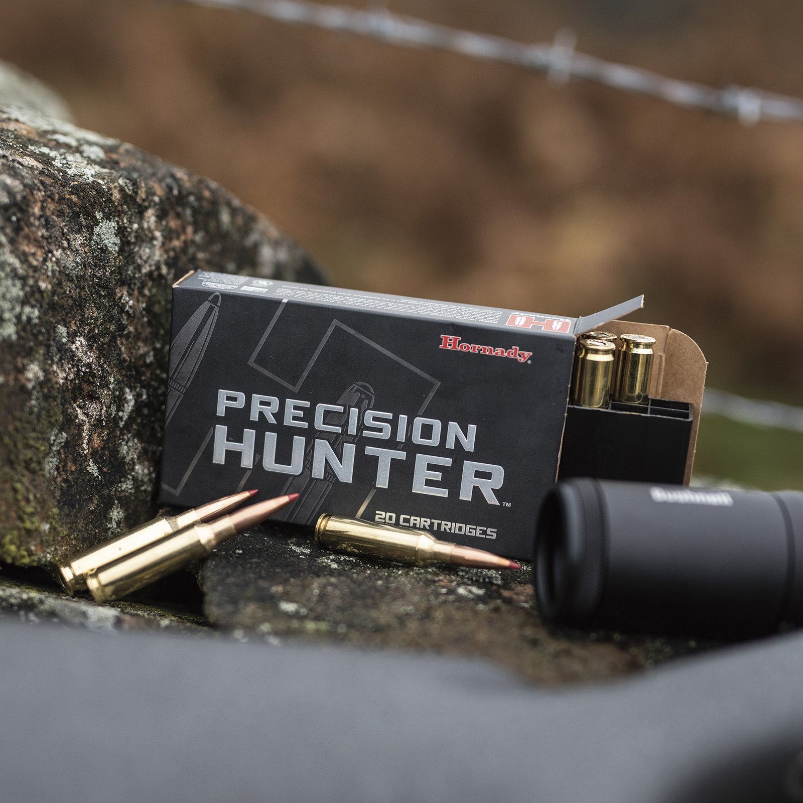 Box of Hornady Precision Hunter ELD-X cartridges with rounds on a stone wall