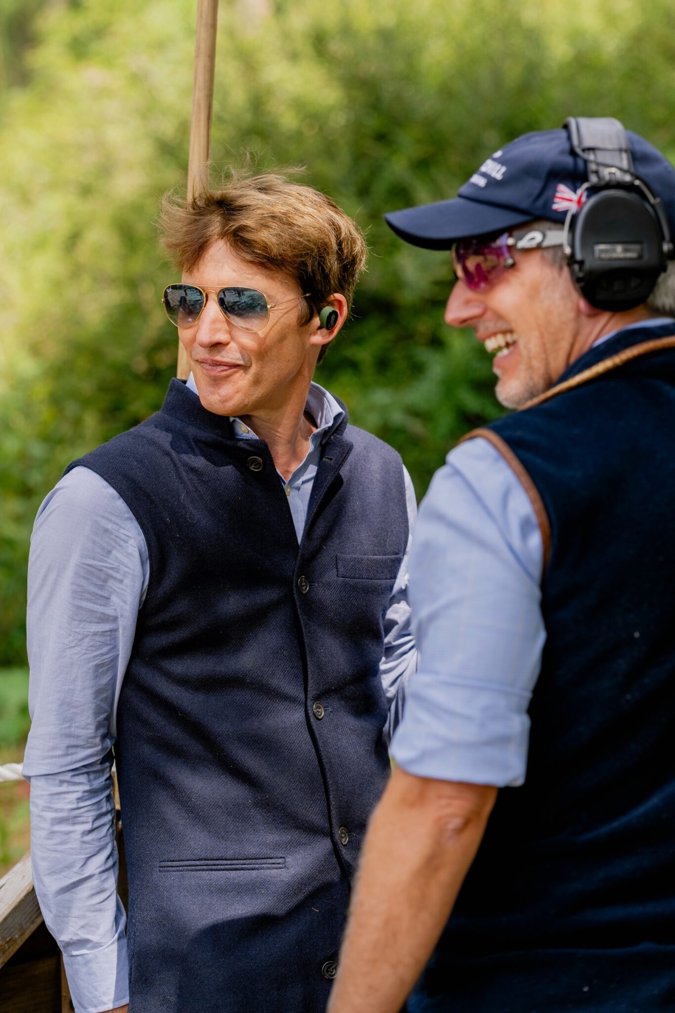 James Blunt in sunglasses talking to an E.J. Churchill instructor at Clays for a Cause