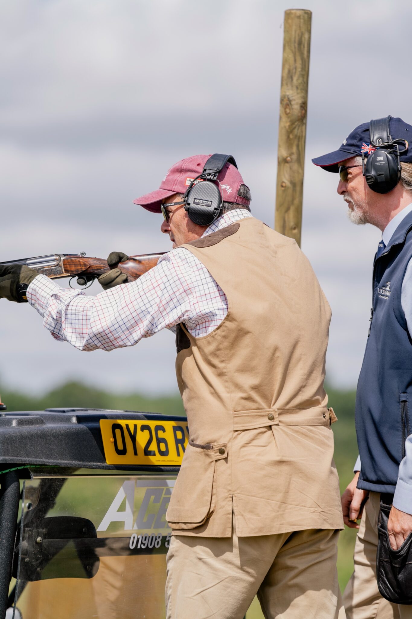 A Gun in a Tour de 4 cap mounting a shotgun with an instructor alongside at Clays for a Cause