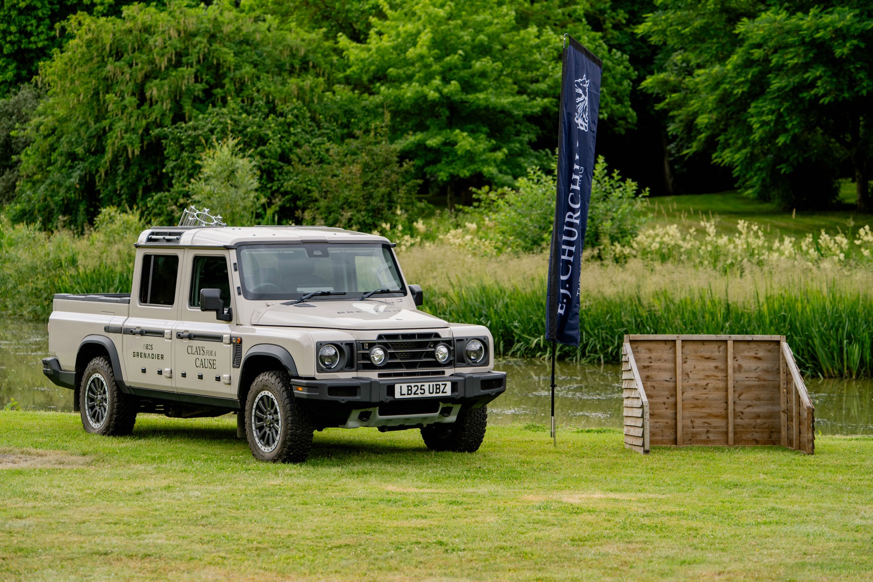 Ineos Grenadier in Clays for a Cause livery parked beside the lake