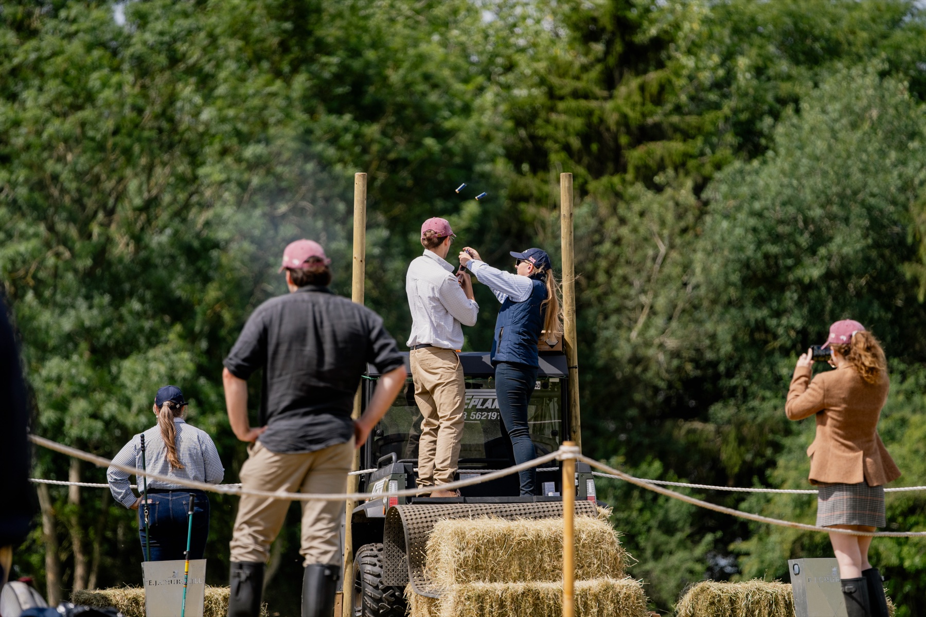 Shooting from a raised stand at Clays for a Cause while spectators watch