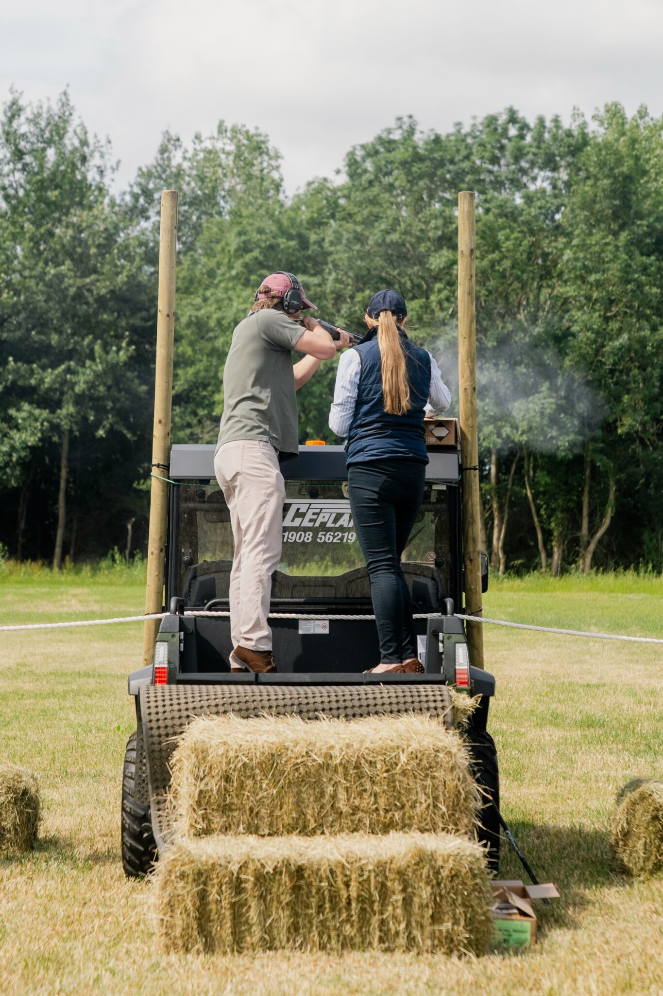 Two Guns on a raised stand above straw bales at Clays for a Cause