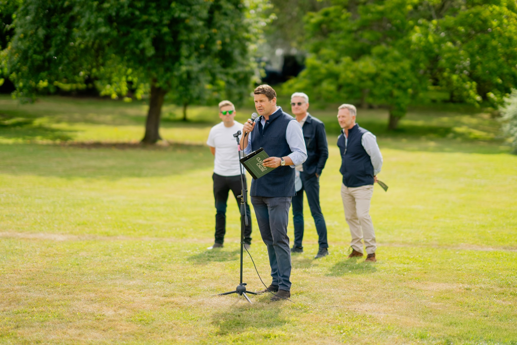 The welcome being given on the lawn at Clays for a Cause with David Coulthard and Christian Horner listening