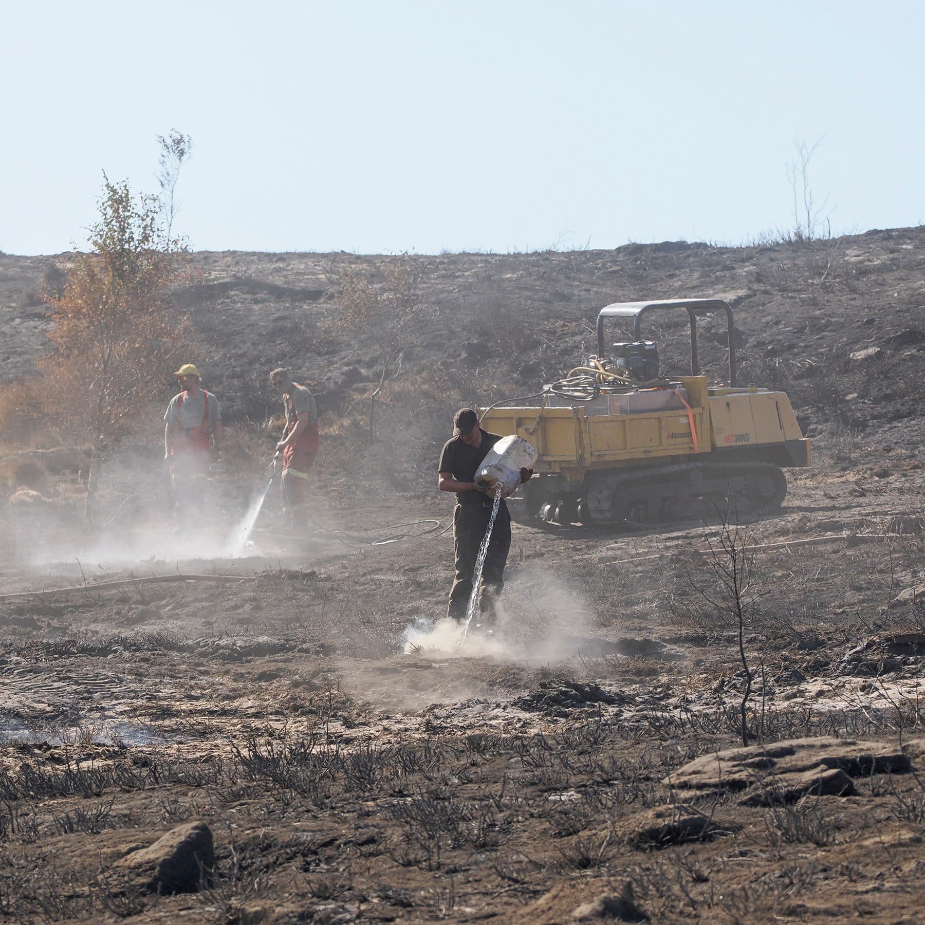 Gamekeepers using a water fogging unit and Argocat to damp down burnt moorland after the Peak District wildfire