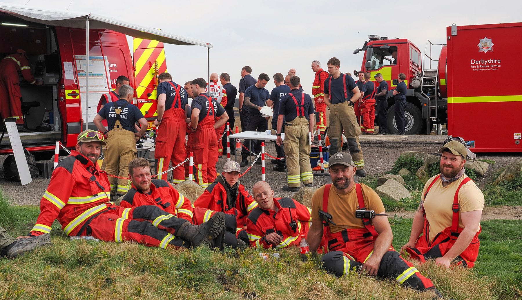 Peak District gamekeepers resting alongside fire and rescue crews and appliances during the Tintwistle Moor wildfire