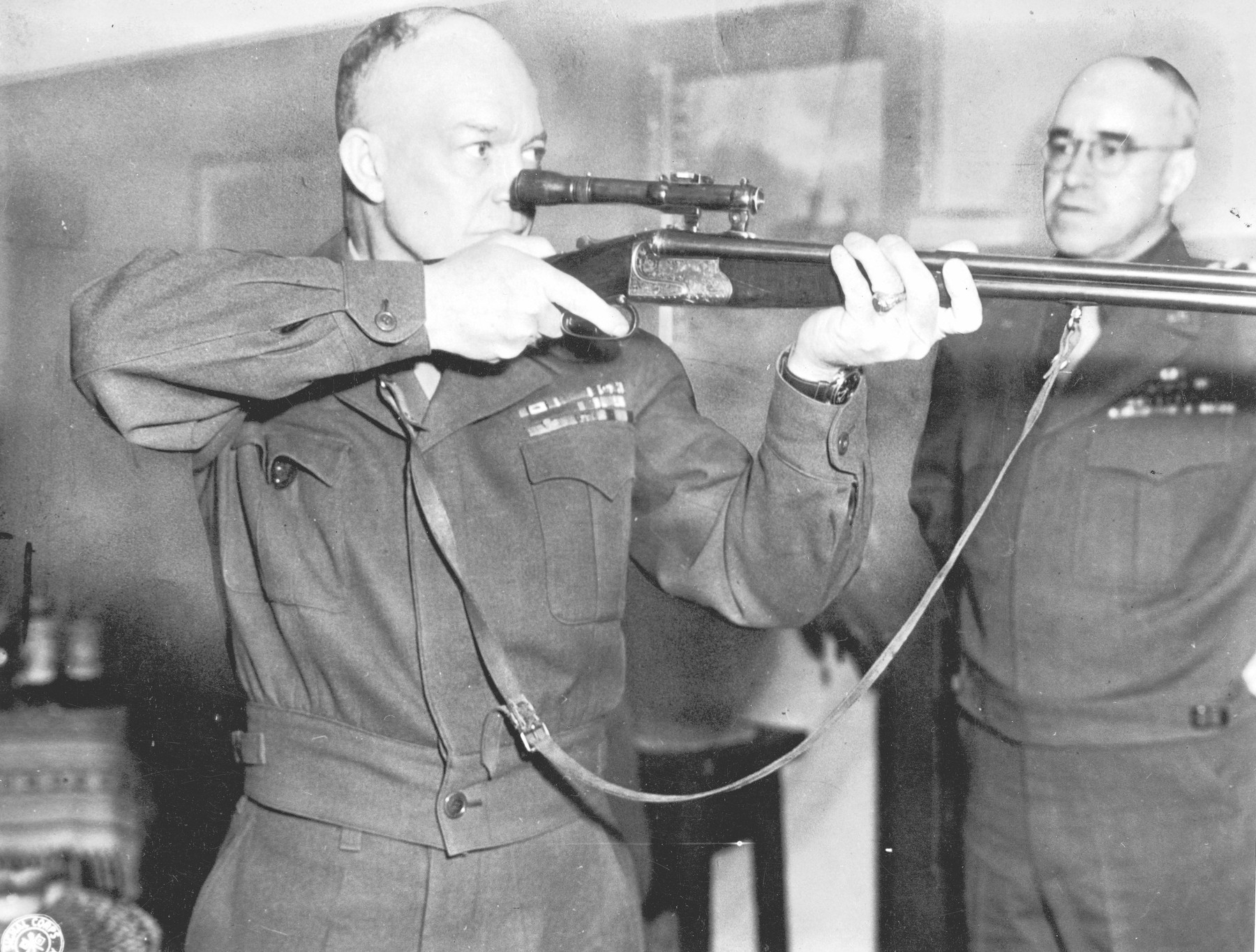Dwight D Eisenhower firing a German combination rifle-shotgun fitted with a telescopic sight