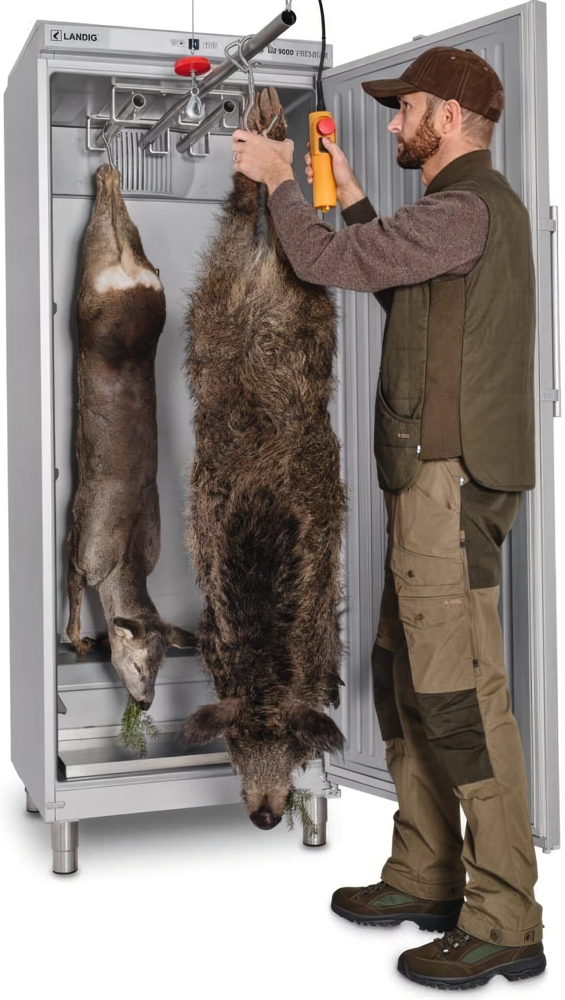 A stalker hanging carcasses in a Landig LU9000 game larder refrigeration unit