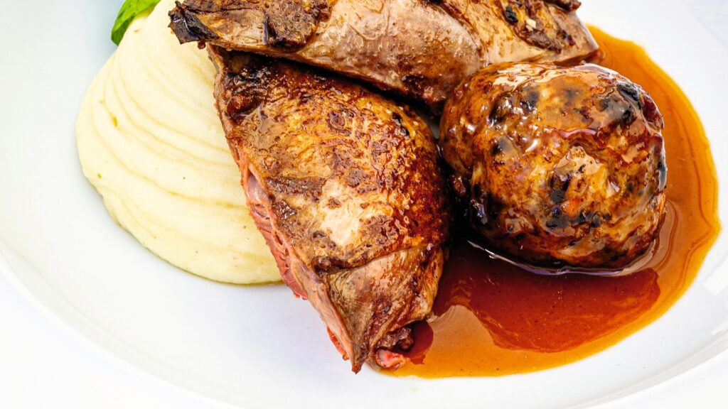 Roast grouse with a Cumberland sausage and black pudding faggot