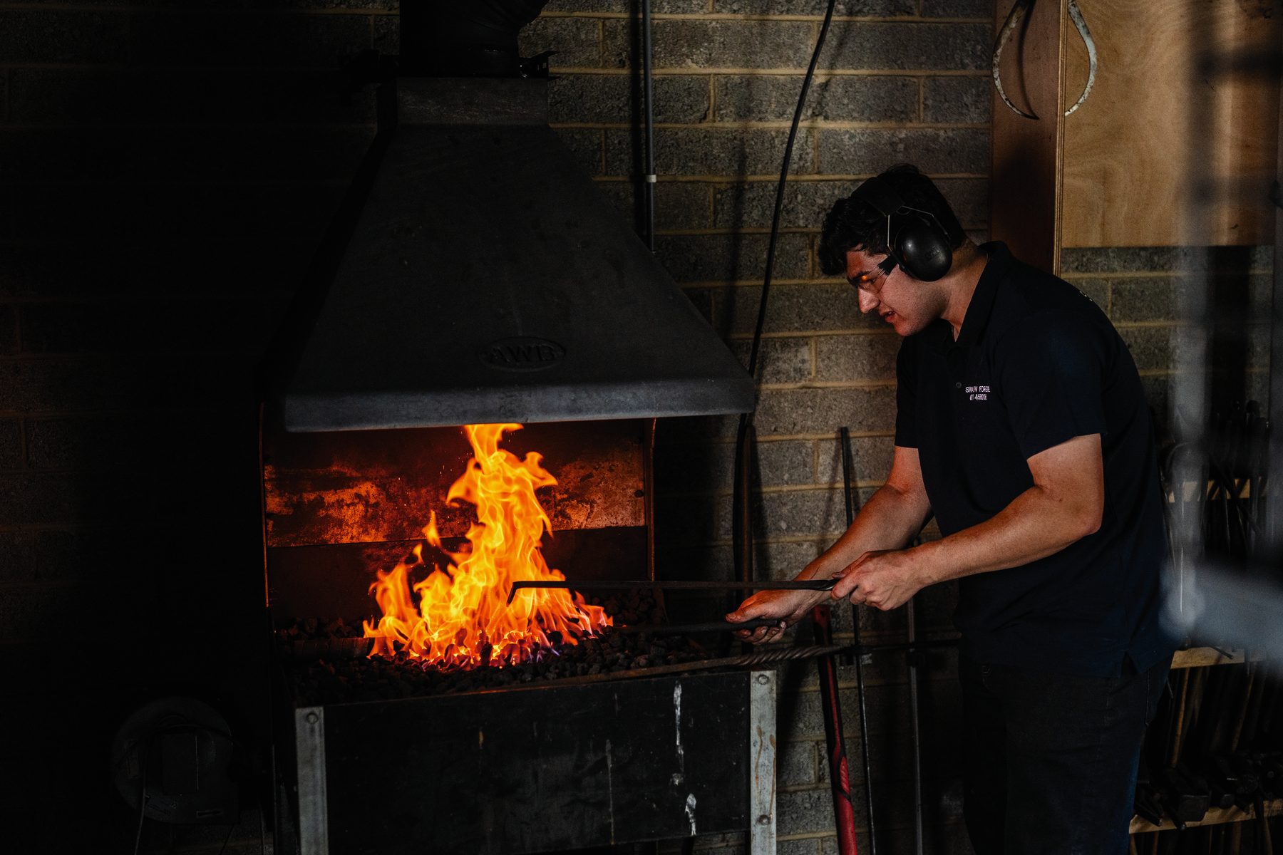 Toby Smith heating a barrel tube in the fire of his forge