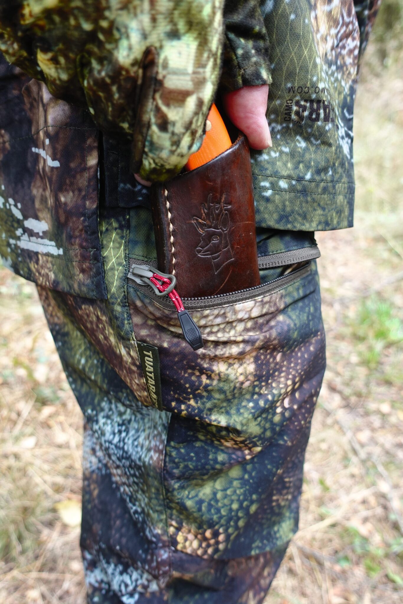 The Stoney Creek Fast Hunt Ascent trousers in camouflage, showing the zipped thigh pocket