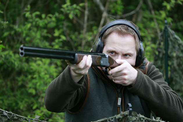 Man taking aim with a 28-bore shotgun